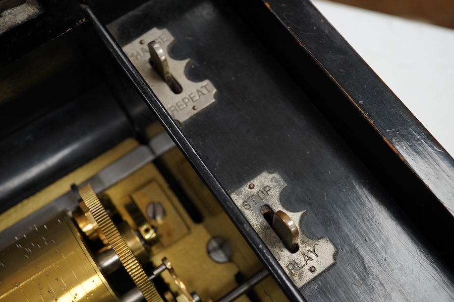 A late 19th century Swiss rosewood ten air cylinder music box, with inlaid lid decorated with musical instruments and foliage, paper label listing the airs to inside of lid, with sixty two tooth comb, cylinder 28cm, case